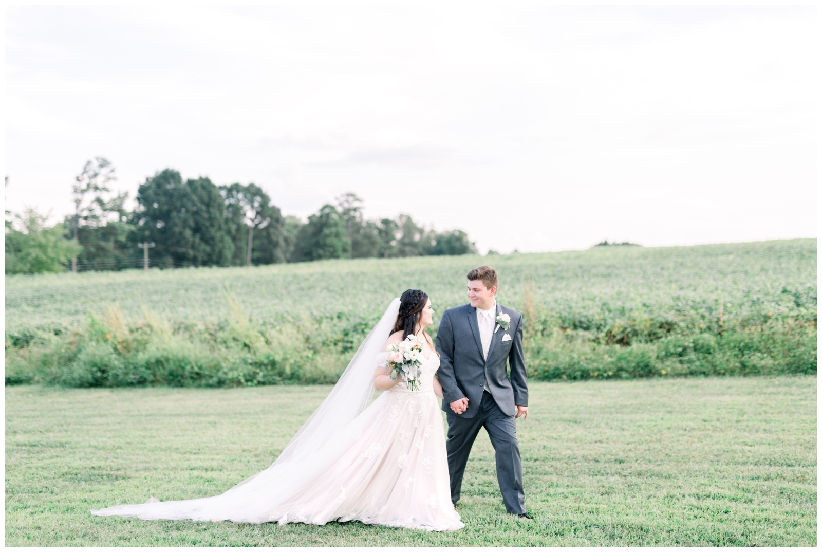 bride and groom walking across field, atlanta ga wedding photographer