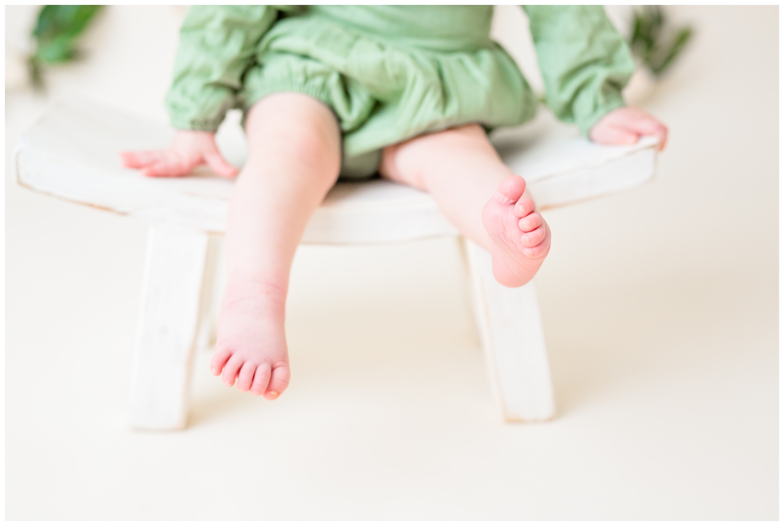 close up 1 year old sitting on stool, baby toes, studio session